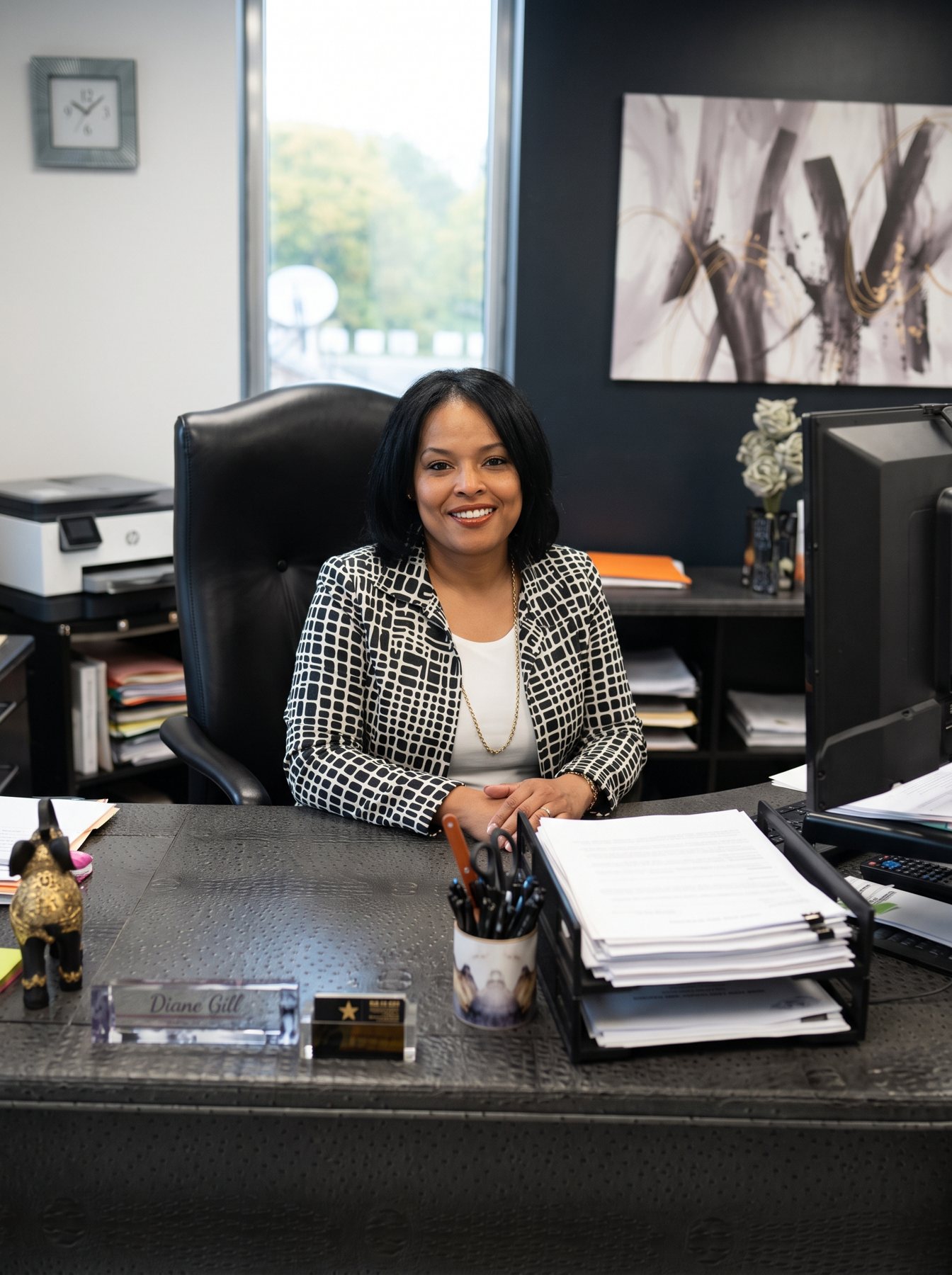 Diane Gill seated behind her desk at 1st Financial Services